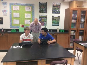 Mr. Swanson helping two students