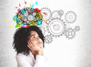girl gazing up, colorful brain and wheels